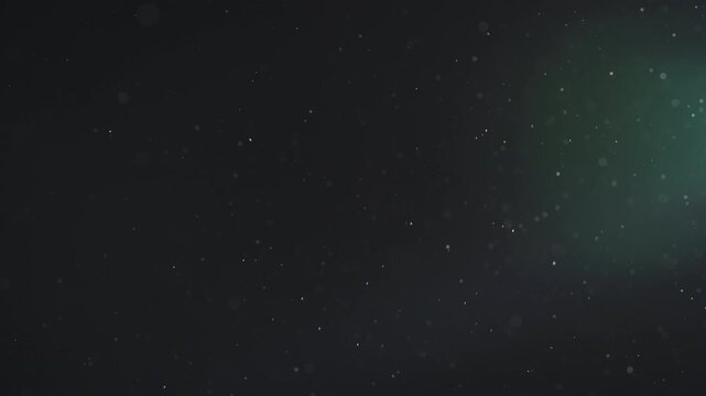 Slow motion real dust particles floating mid air over dark background