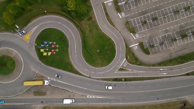Navigating the Asphalt Maze: An aerial view of a meticulously designed driving test facility, showcasing intricate road patterns, parking areas.