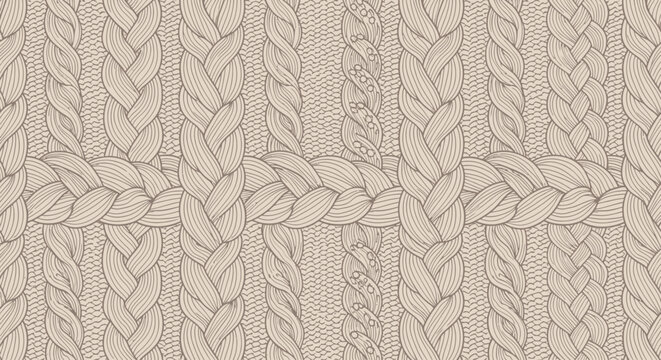 Close-up view of beige knitted fabric with various cable knit patterns.