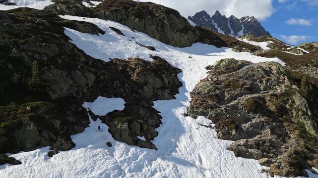 Cinematic drone flight above snowy alpine peaks overlooking Chamonix town in the valley, France, captured in slow motion