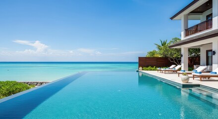 Fototapeta premium A stunning luxury beach resort featuring a pristine infinity pool overlooking calm turquoise ocean waters under a clear blue tropical sky, tree, infinity, resort