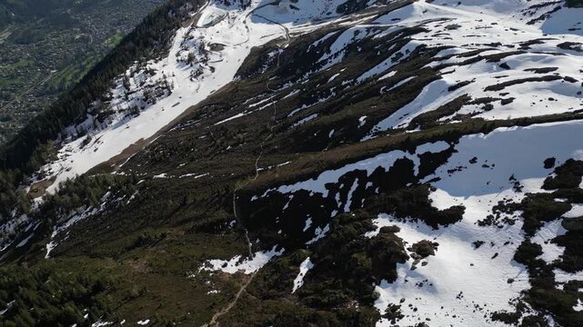 Cinematic drone flight above snowy alpine peaks near Lac Blanc in Chamonix, France, captured in slow motion