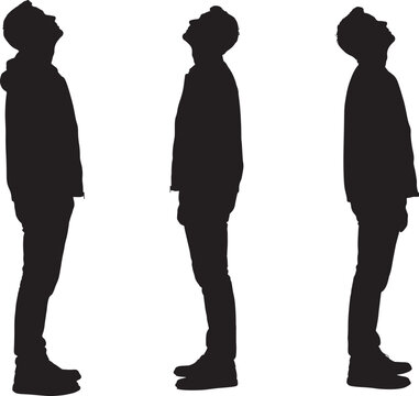 Silhouettes of three men standing and looking up 
