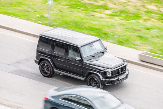 Mercedes Benz G Class W463 model on city road in motion, above front side view