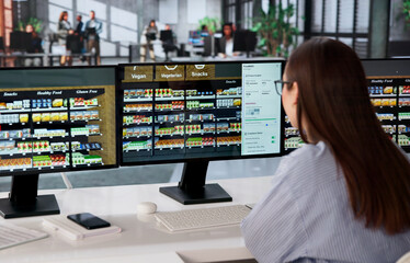 Young Retail Manager Uses Software On Computer