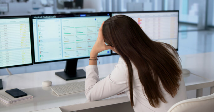 Hospital Administrator Reviews Multiple Patient Billing Screens