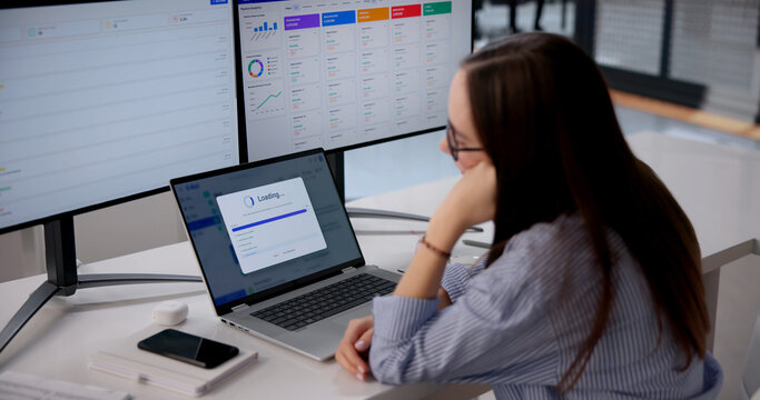 Young Female Employee Waits At Slow Loading Bar, Frustrated