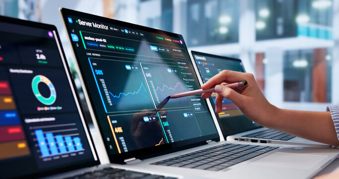 Young Woman Monitors Network Data On Laptop