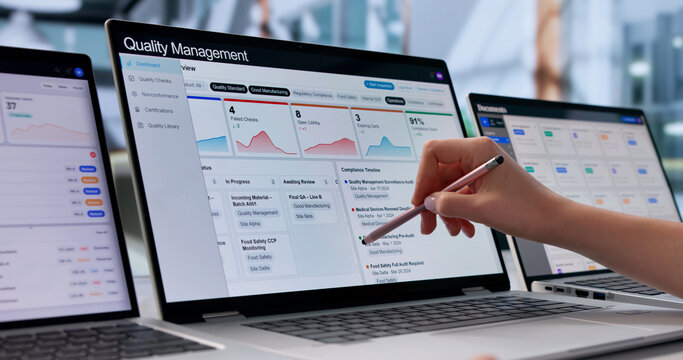 Young Female Quality Manager Reviewing Corrective Actions On Laptop