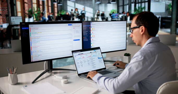 Middle-aged Man Uses Laptop Reviewing CAPA Reports