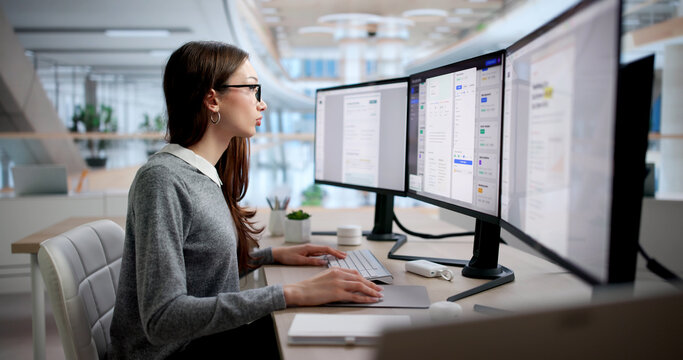 Young Businesswoman Uses Computer To Manage Documents