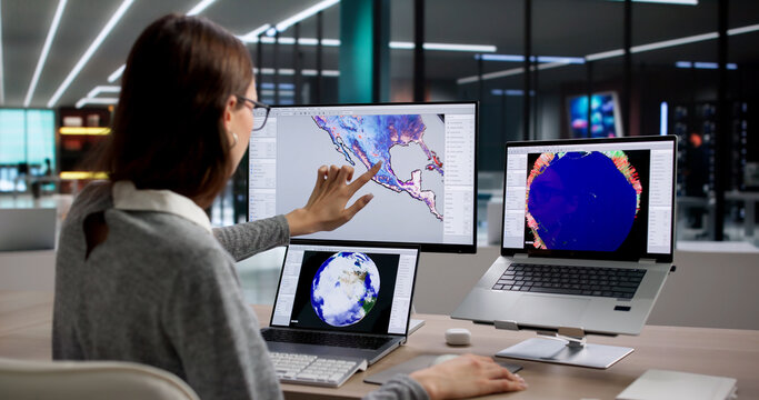 Young Woman Analyzes Weather Map On Laptop