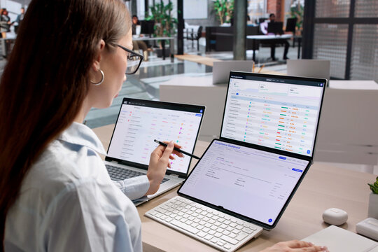 Woman Uses Laptop Reviewing Regulatory Dashboard