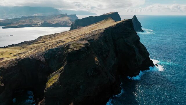 Aerial view of rocky cliffs and steep coastline of Sao Lourenco peninsula on Madeira island, Atlantic Ocean. Volcanic headland with rugged terrain