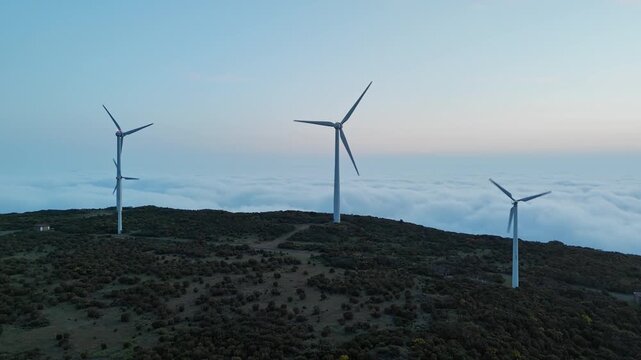 Aerial view of wind farm above clouds, energy transition and decarbonization in mountainous region of Madeira, Portugal