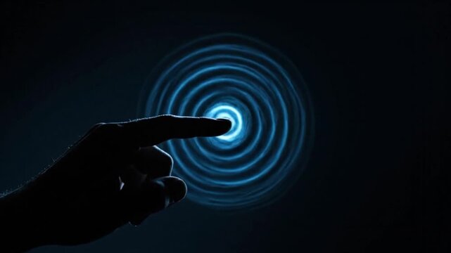 Close Up Silhouette of a Human Finger Touching a Glowing Blue Digital Interface Creating Circular Energy Ripples in the Dark