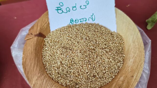 Closeup view of brown top millet grain displayed at krishi mela showcasing small grains and texture