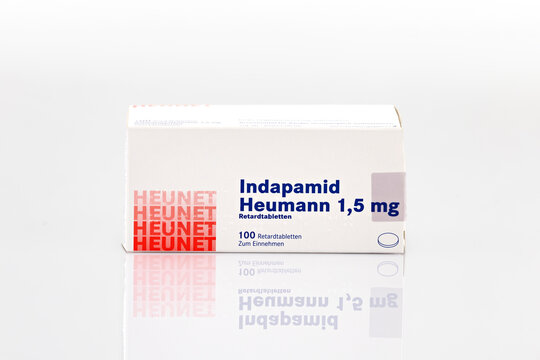 Indapamid Heumann 1.5 mg medication box isolated on light background. Illustrative editorial studio product photography of pharmaceutical packaging and healthcare product.