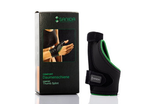 Sanida Comfort thumb splint orthopedic support with retail packaging isolated on light background. Illustrative editorial studio product photography for healthcare and rehabilitation concepts.
