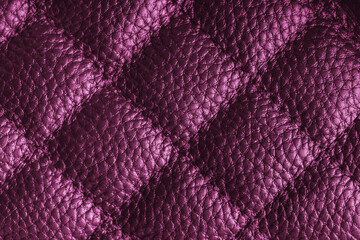 Fototapeta premium Close up, macro of pink quilted leather texture with stitched diamond pattern, luxury material surface shining metal effect for fashion, upholstery or design wallpaper, rough, relief background