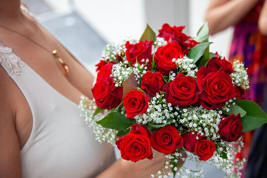 Bride Holding Bouquet of Red Roses