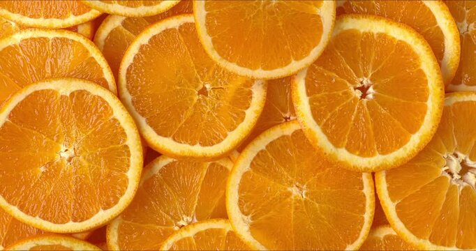Top view of unpeeled orange slices as a background texture. 