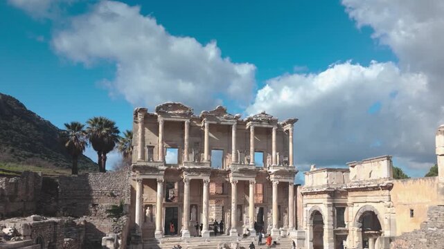 Sunlit Grand Library Facade With Visitors And Photographers Framing Shots, Vivid Blue Sky And Soft Clouds