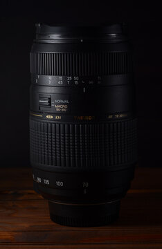 PERPIGNAN, FRANCE - MAY 9, 2026: A Tamron AF 70-300mm f4-5.6 Di LD Macro (Model A17) zoom lens for Nikon cameras on a wooden surface. This telephoto lens is a popular choice for budget-friendly.