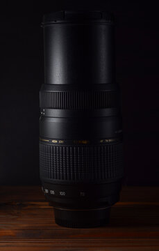 PERPIGNAN, FRANCE - MAY 9, 2026: A Tamron AF 70-300mm f4-5.6 Di LD Macro (Model A17) zoom lens for Nikon cameras on a wooden surface. This telephoto lens is a popular choice for budget-friendly.