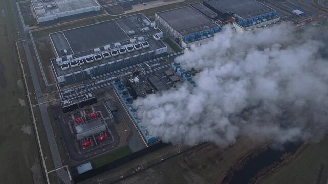 Aerial view of google data center emitting steam from cooling systems