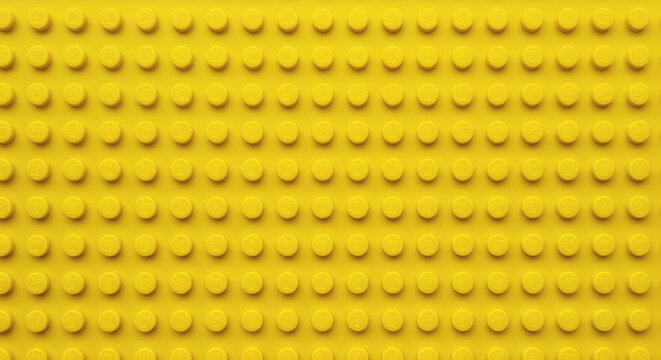 Yellow plastic building block plate texture background for kids toys