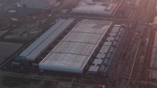 Aerial view of google data center with wind turbines at sunrise