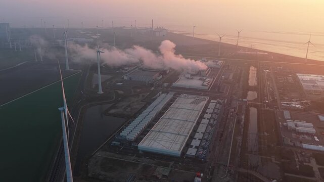 Aerial view of google data center and wind turbines at sunrise
