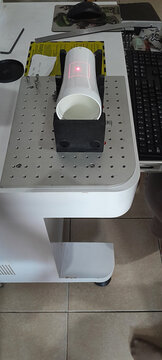 The process of engraving a white tumbler using an engraving machine