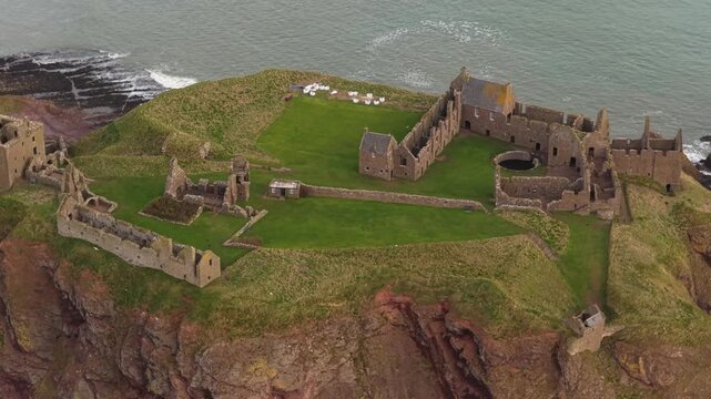 Aerial view of historic dunnottar castle ruins on a cliff in scotland