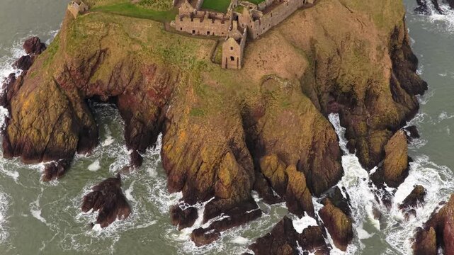 Aerial view of dunnottar castle on a rocky headland in scotland