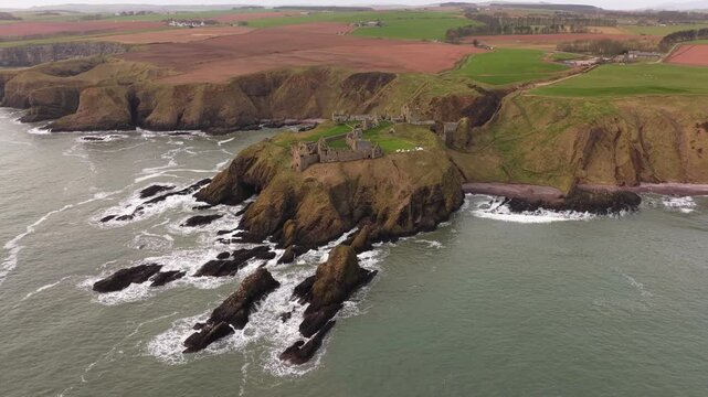 Dramatic dunnottar castle aerial view on a cliff in scotland