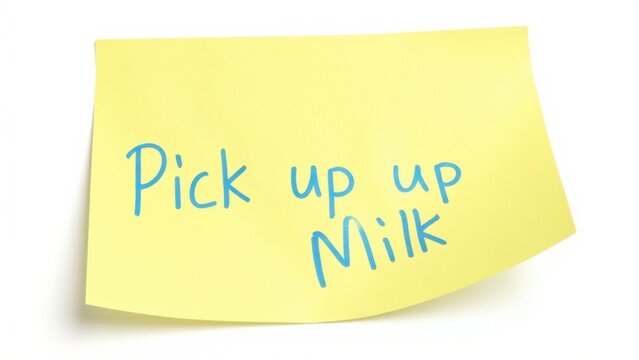 Yellow sticky note with written reminder on white surface.