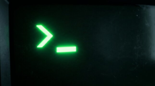 Green command line prompt on vintage computer monitor with glowing blinking cursor symbol.