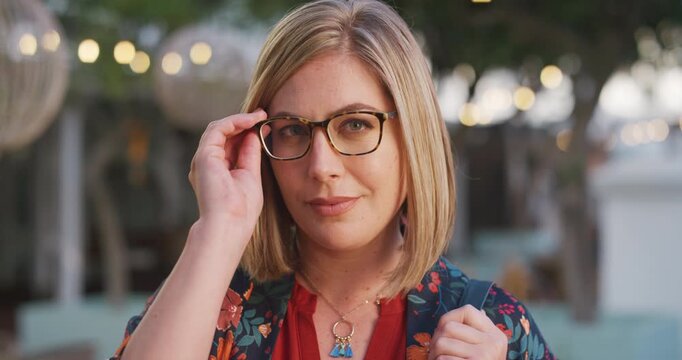 Face, woman and commute in city with glasses, prescription eyewear or vision for marketing career. Bokeh, person and spectacles in urban town with eye care, optometry or travel to advertising agency.