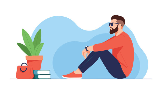 Bearded man wearing sunglasses and red sweater sitting on floor in relaxed pose next to green houseplant and stack of books.