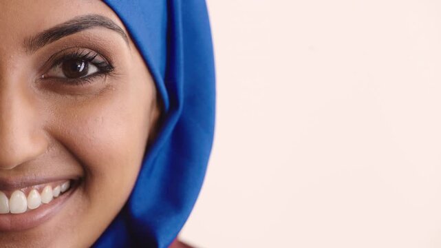 Face, half and Muslim woman with hijab, makeup and confident with beauty, mockup space and cosmetics. Studio background, religion and person with headscarf, shine and smile with eyeshadow in Somalia