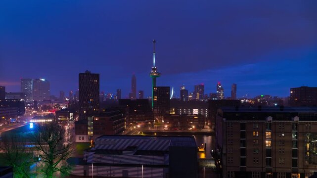 Rotterdam, Netherlands. Aerial view of the city Rotterdam, Netherlands during the night with cloudy sky. Time-lapse at sunrise with car traffic