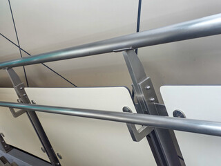 Naklejka premium Close up view of metal steel handrail barrier panel on public walkway providing calm steady and secure feeling for daily transportation transit commuting and urban indoor travel infrastructure