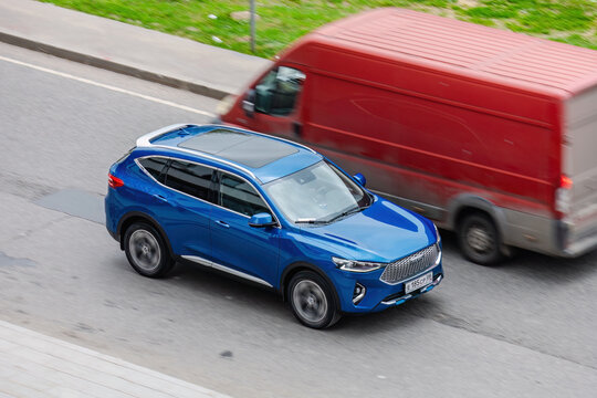 Blue Haval F7 SUV car moving in the street on high speed, above front side view