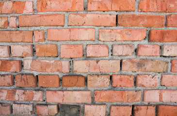 Fototapeta premium Weathered brick masonry wall close up