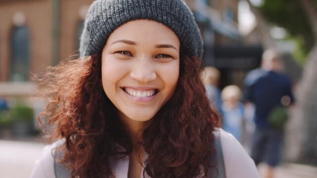 Outdoor, face and woman with smile for travel, international student and pride for study opportunity. Confident, wind or person with portrait for education abroad, exchange programme or learn culture
