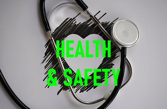 Stethoscope and heart-shaped shadow with the words health and safety. Employment concept. Protecting the safety, health, and welfare of people in the workplace, preventing accidents, injuries, and occ
