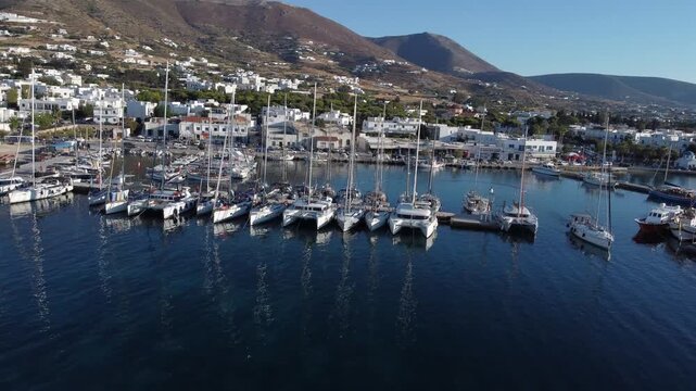 Docked boats and yachts in coastal town of greek island on aegean sea, Paros, Drone shot