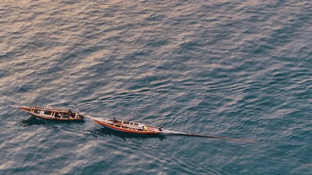 Fisherman on a wooden dhow in Lake Tanganyika, capturing traditional fishing and lakeside life in Tanzania.